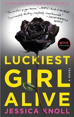 A gray cover with a black rose on the front. The title is in big yellow letters and the authors name is in pink.