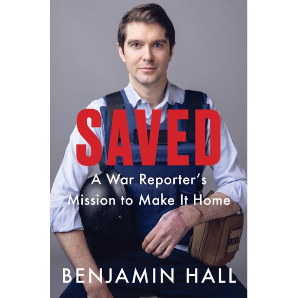 Cover features Benjamin Hall himself in a white button down with a bullet proof vest, sitting and facing the reader. He has what looks to be a helmet under one arm and a brown canvas bag. 