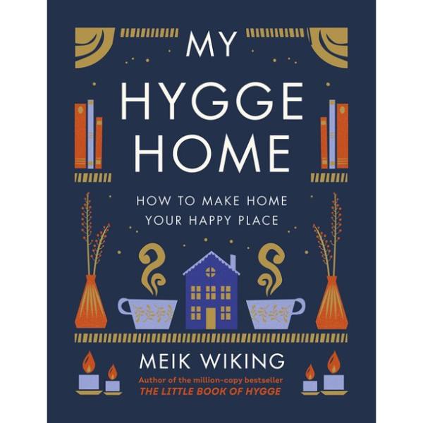 Dark blue cover features cozy items like candles, warm cups of tea, books, and a welcoming house.
