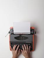 Photo of hands on a typewriter.