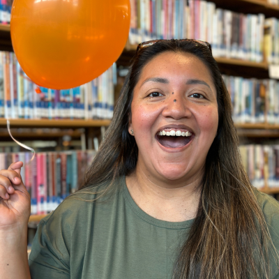 Kelley Watson holding an orange balloon